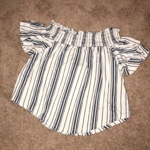A white off the shoulder, striped navy blue shirt